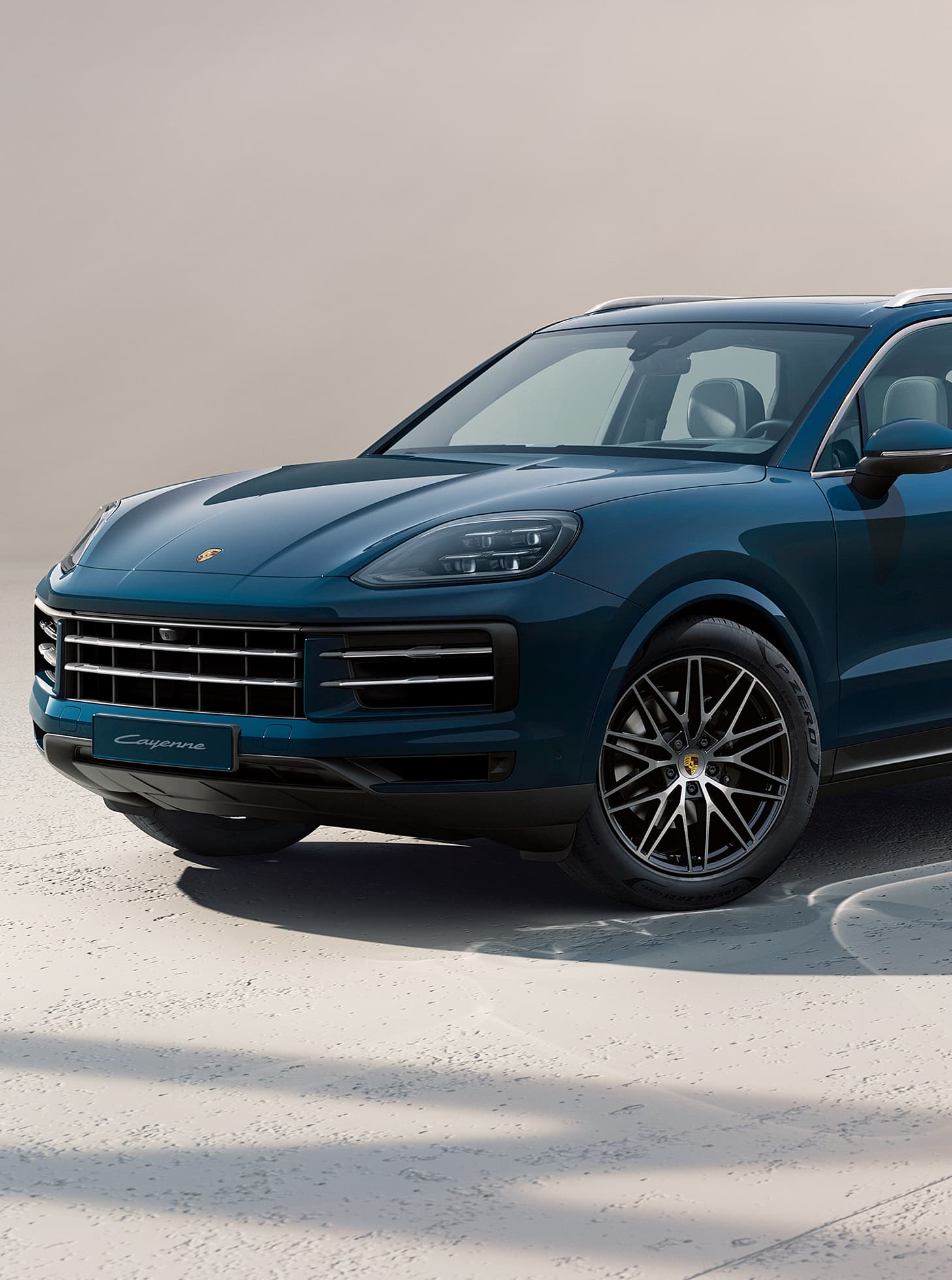 A Porsche Cayenne driving on an open road.
